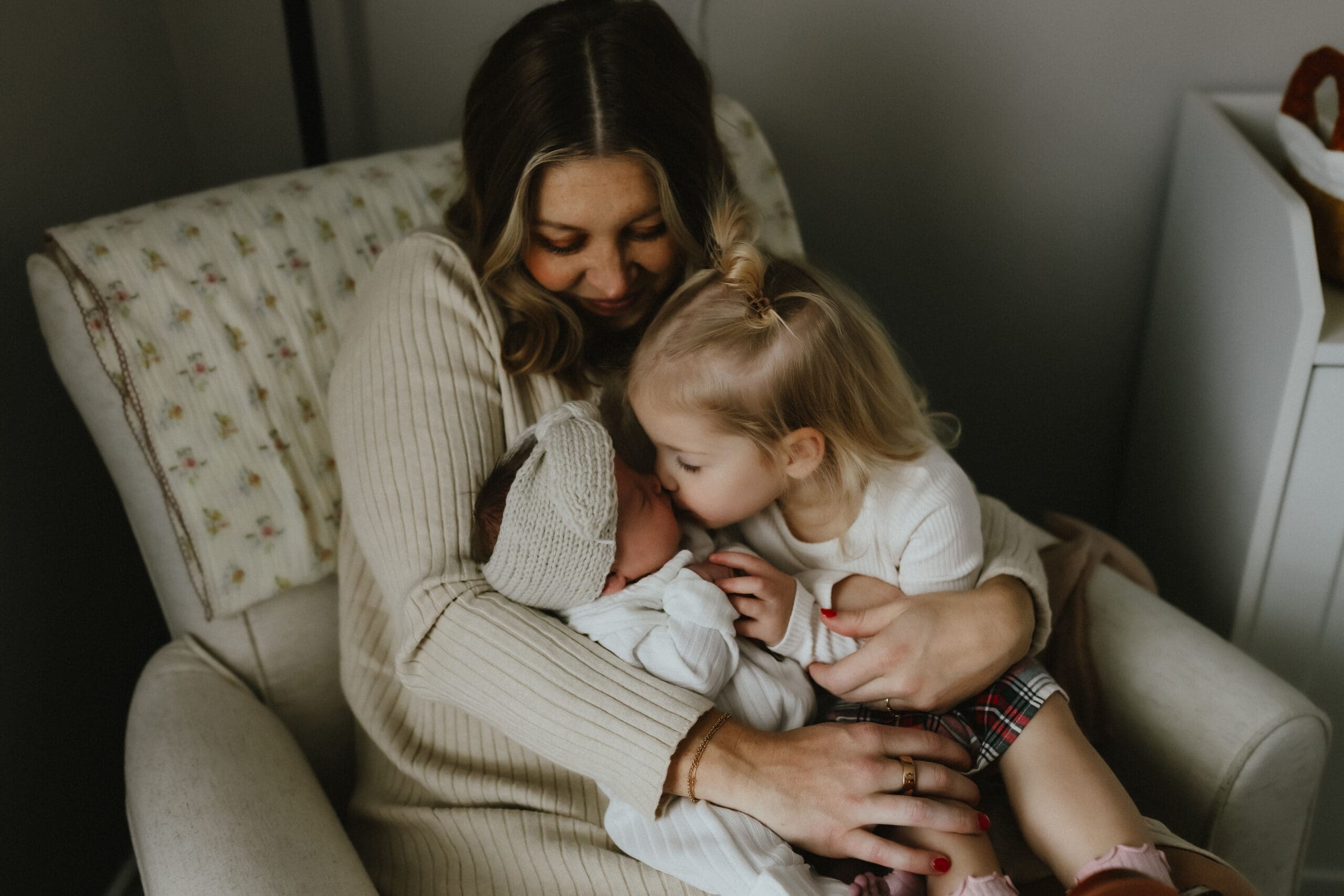 mom and daughters cuddling together
