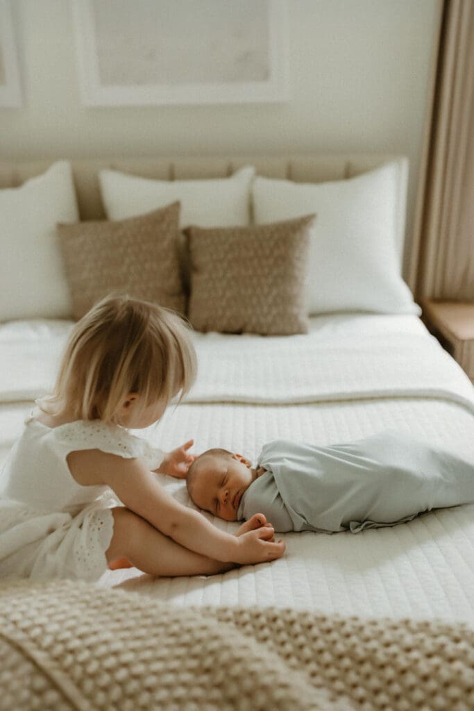 sibling photograph of new baby and sister during south bend photo session