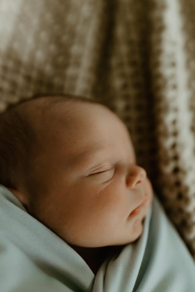 close-up photograph of newborn baby's nose and face during photo session