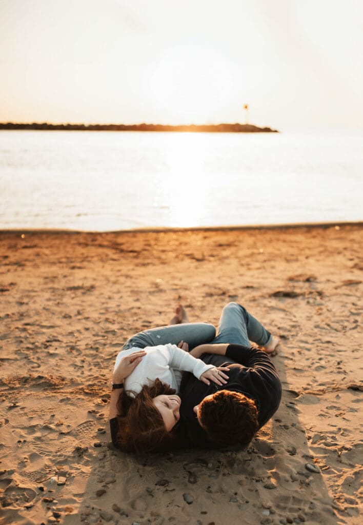 engagement photograph of couple on the beach in new buffalo michigan