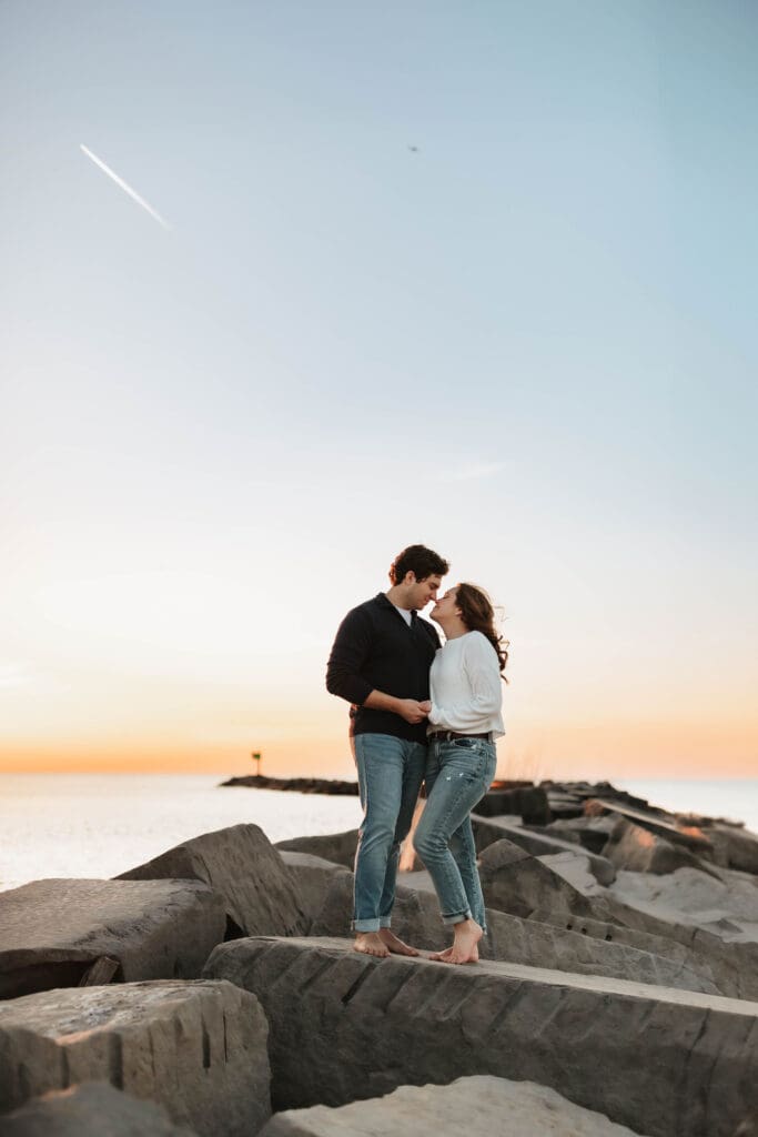 couple standing on rocks in new buffalo michigan