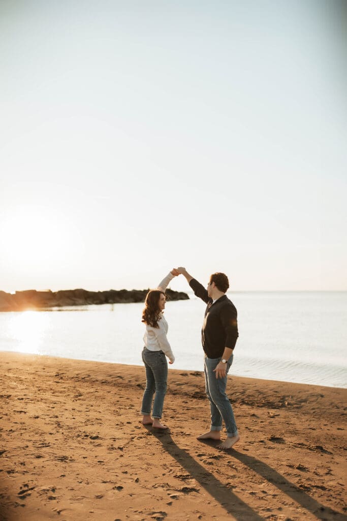 dancing engaged couple at sunset during new buffalo photo session