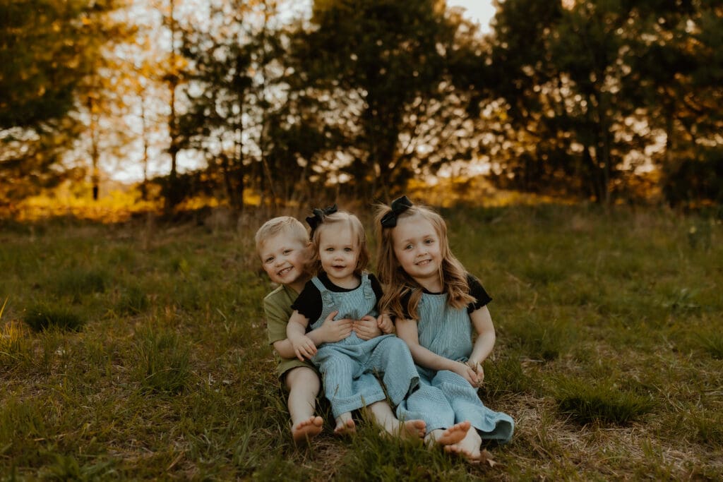 family photos at Cobus Creek County Park with kids playing in field