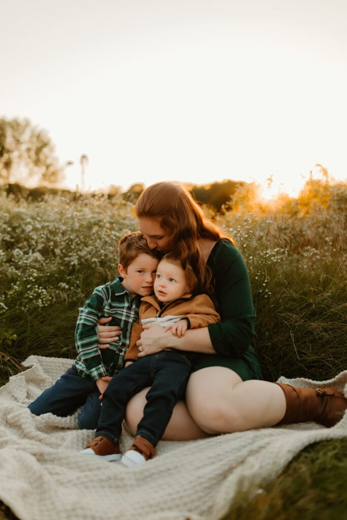 Mom holding her children during sunset family photos