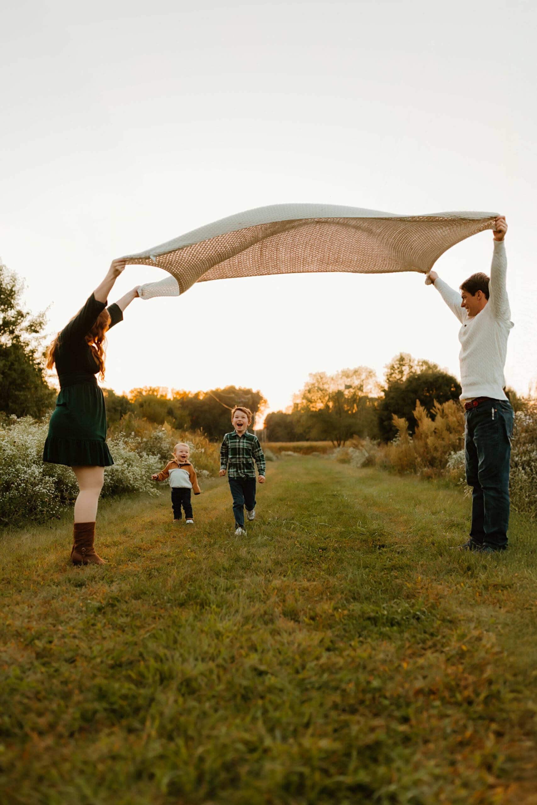 A candid playful photo of family together during fall photoshoot