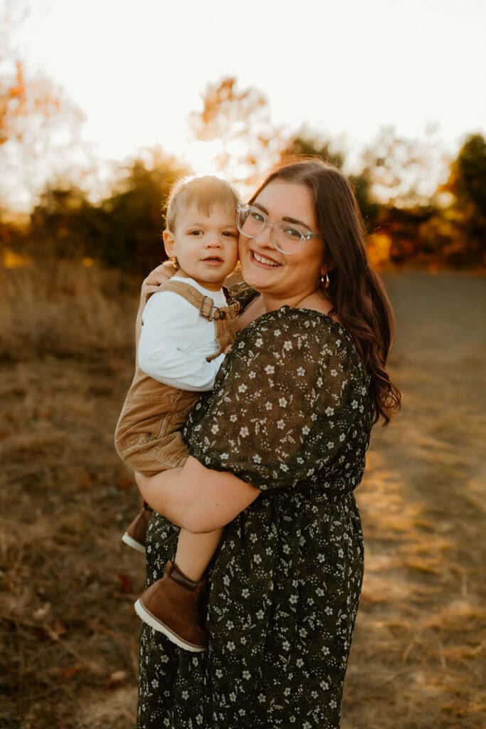 mom and baby smiling at camera during fall photography session in south bend