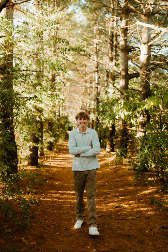 south bend senior photoshoot in tree line at st patrick's county park