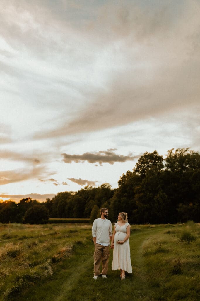 maternity photographer in south bend captures golden hour sky with baby bump 