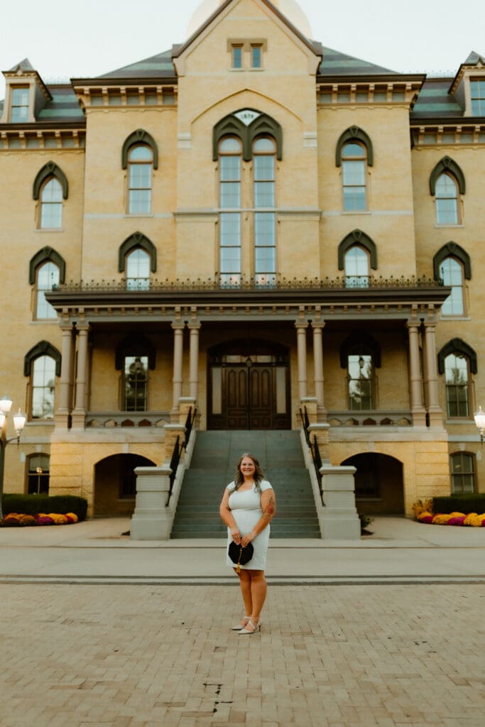 Notre Dame senior photos with graduate walking through campus