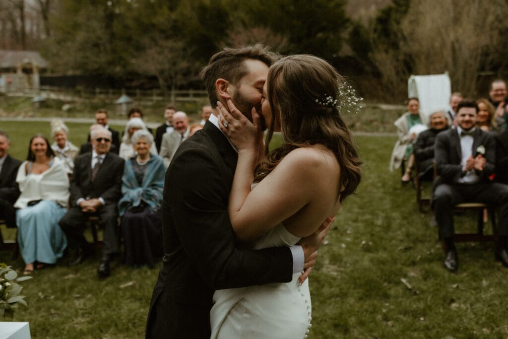 bride and groom kissing after ceremony outdoor wedding