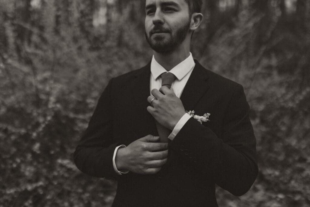 black and white groom photograph during outdoor wedding