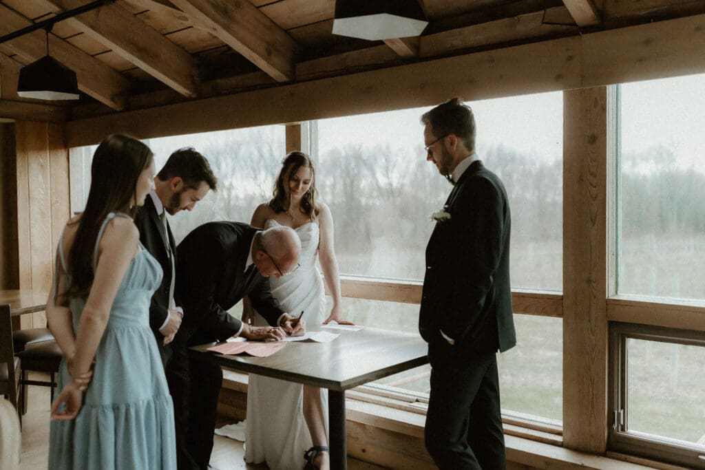 officiant signing wedding certificate