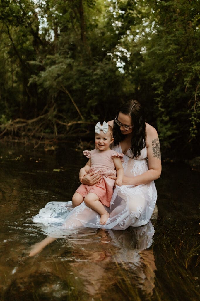 mom and child playing in creek