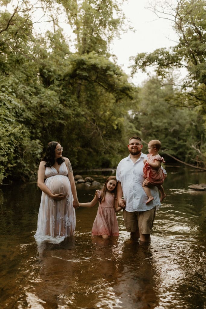 family walking in a creek during elkhart photoshoot