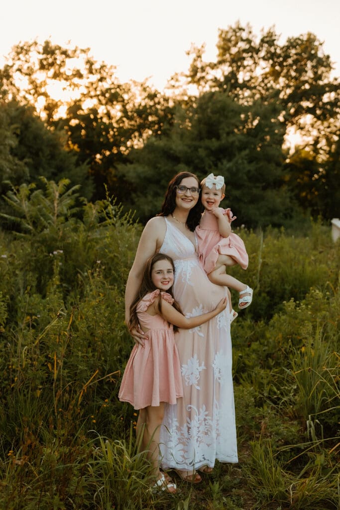 mother and daughters at cobus creek county park during golden hour