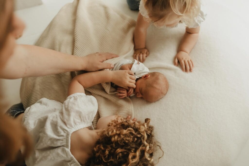 baby and sisters during south bend studio photography session