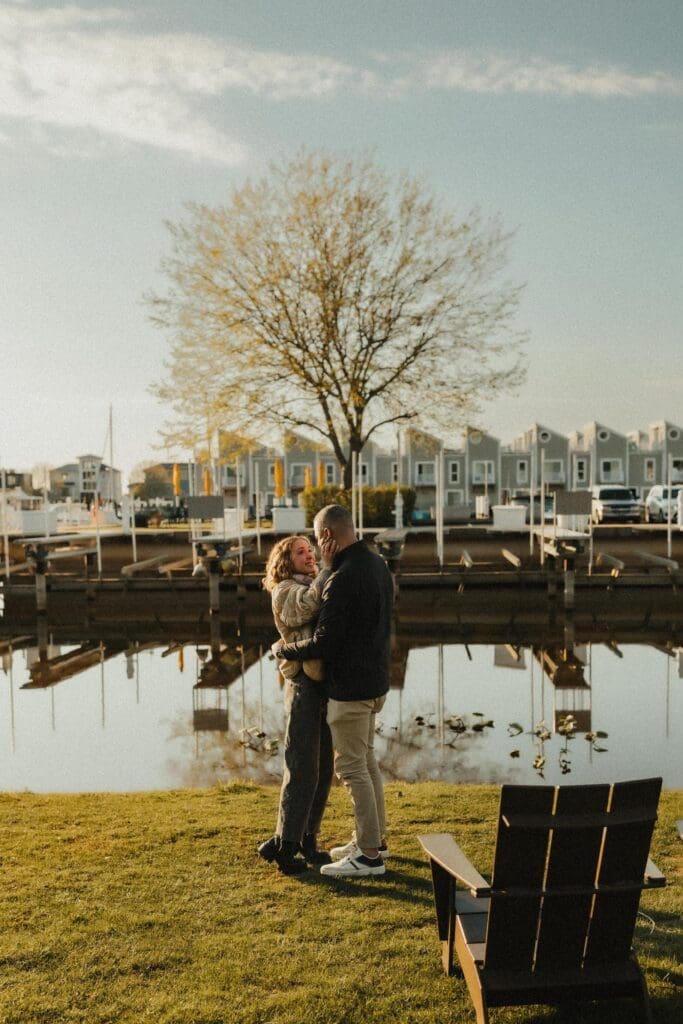 Couple embrace after proposal at The Grand Harbor in New Buffalo Michigan 