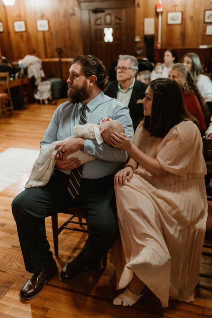 mom and dad with child at notre dame baptism