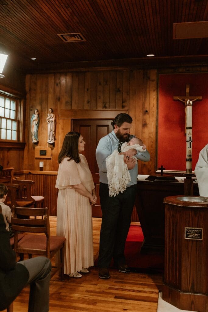 Baby being baptized during church ceremony at Notre Dame