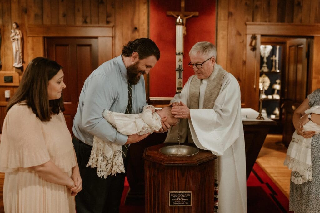 Family gathered during baby baptism ceremony at Notre Dame
