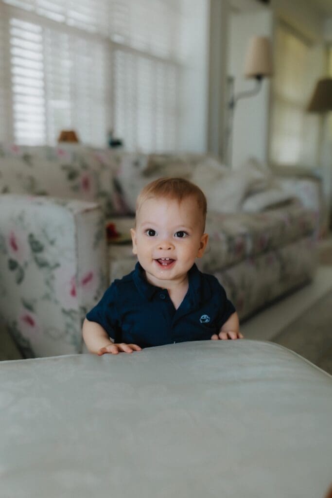 baby smiling at the camera as union pier family photographer takes photographs inside home