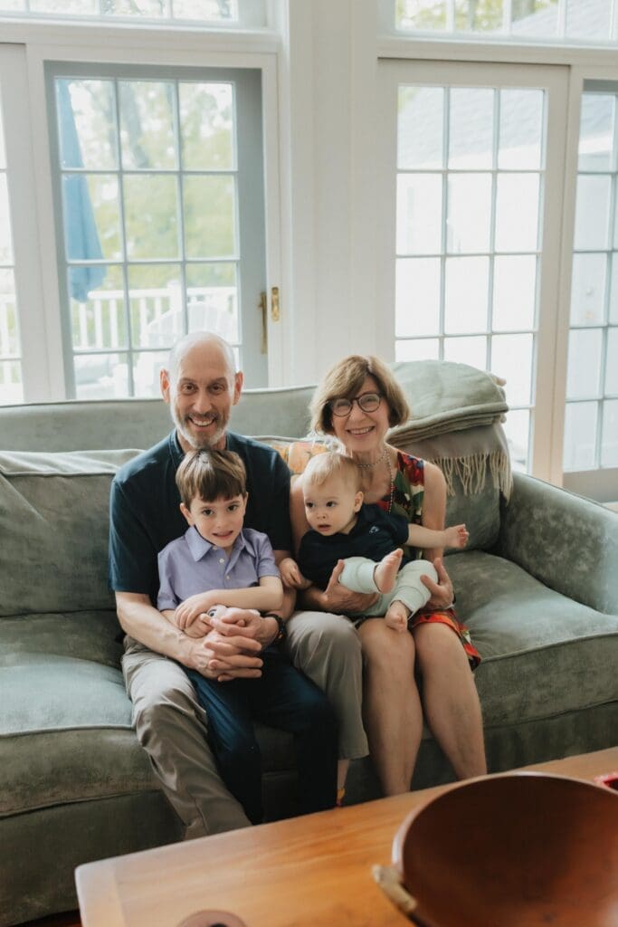extended family portrait on couch in beach house photo session 