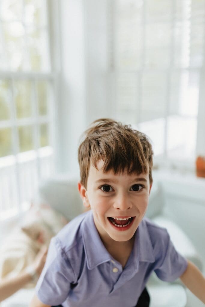 child in beach house laughing
