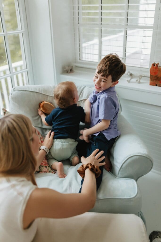 children laughing during candid moment at house in union pier 