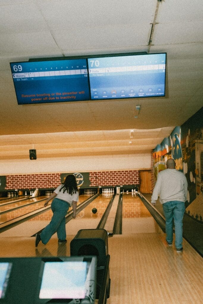 candid photography of couple bowling
