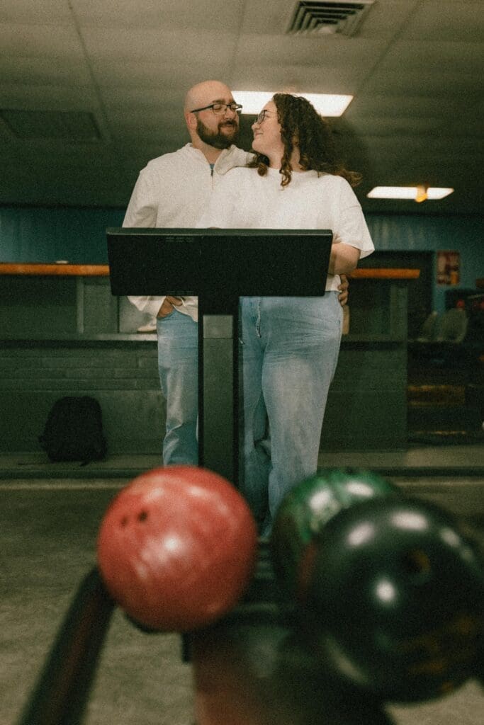 romantic engagement photos inside a bowling alley