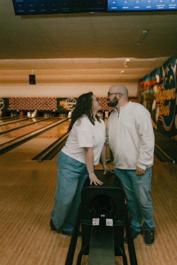 man and woman looking at each other in bowling lane 