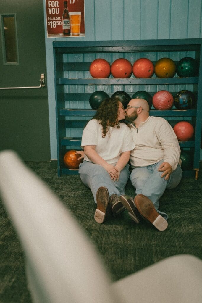 documentary style engagement photography in bowling alley 