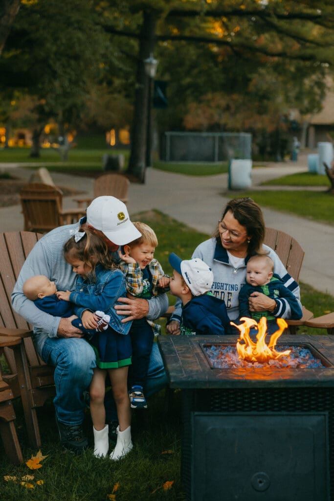 Collage of grandparents and children exploring Notre Dame, sharing cuddles, and riding in a wagon at sunset.